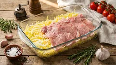 Carré di maiale su patate grattugiate: pranzo da un'unica teglia con crosta di formaggio e panna